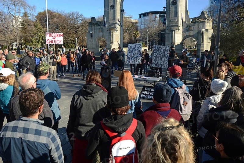 CHRISTCHURCH, NEW ZEALAND, JULY 24, 2021, People gather at a protest rally at the Bridge of Remembrance in Christchurch. Activists spoke against increasing government control over Covid vaccinations, farm taxes and civil liberties