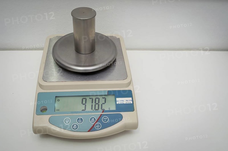 Great concept of research and development, hand measuring the density of a liquid with the pycnometer