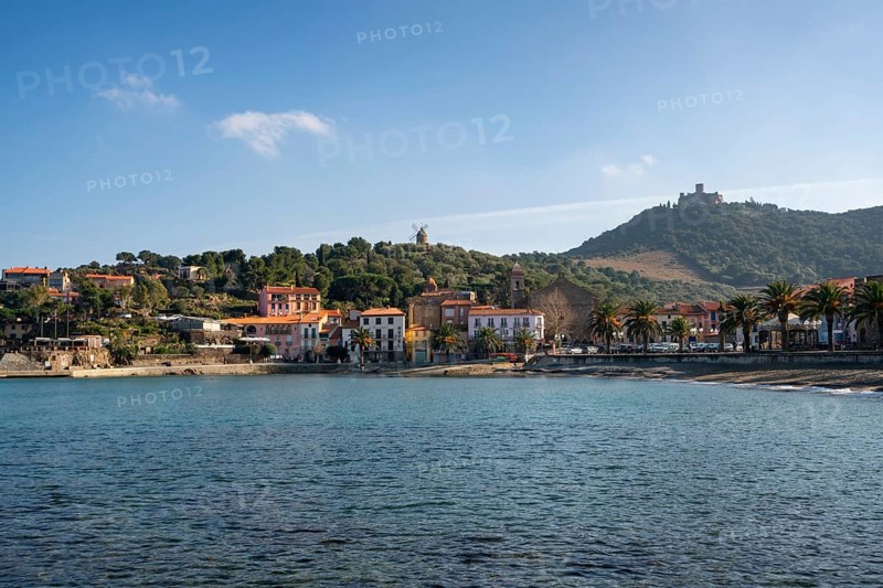 Collioure view from the other side of the bay with Fort of Saint Elme on the top of the village and the beach