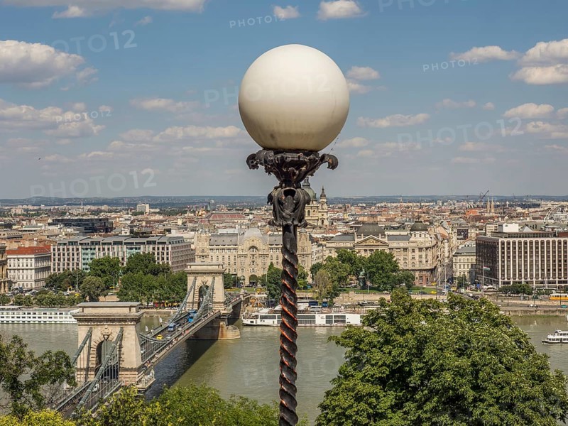 Street lamp with ball lamp and view of the cityscape and the river under a blue sky, budapest, danube, hungary