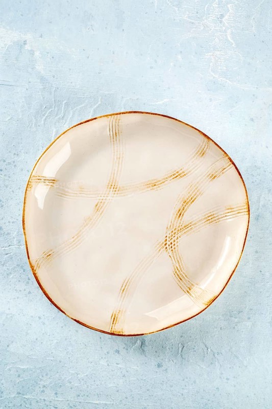 An empty plate with a gold rim, top shot on a slate background, the concept of food, Food photography