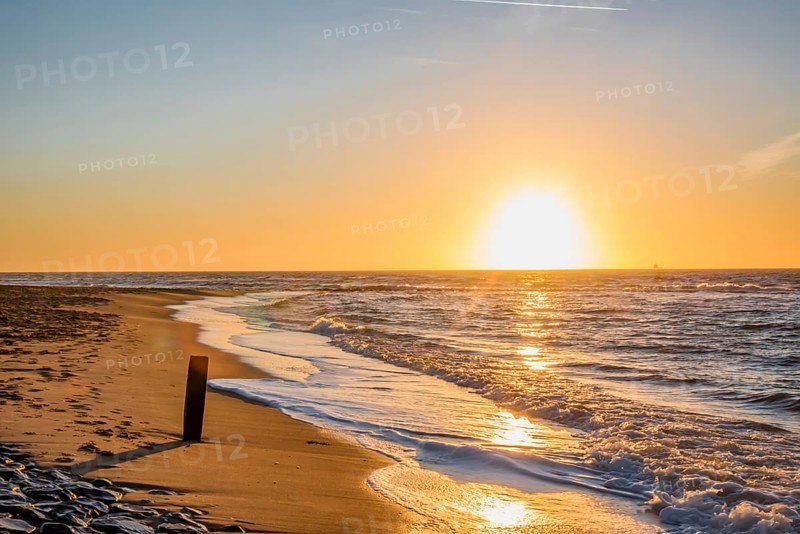 Den Helder, Netherlands. January 2022. Setting sun on the beach of Den Helder, Netherlands.