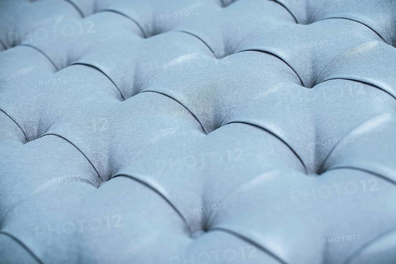 Blue gray upholstered furniture from ement quilted fabric texture. Interior design, headboards made of furniture fabric upholstery. Classic checkered pattern background for furniture, wall, headboard