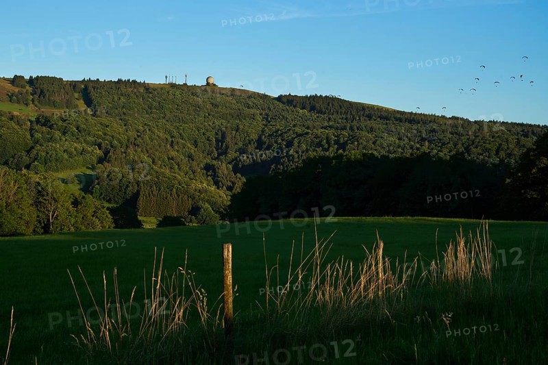 View of the Wasserkuppe with the Random, top right numerous paragliders, evening mood, Rhön, Hesse, Germany, Europe