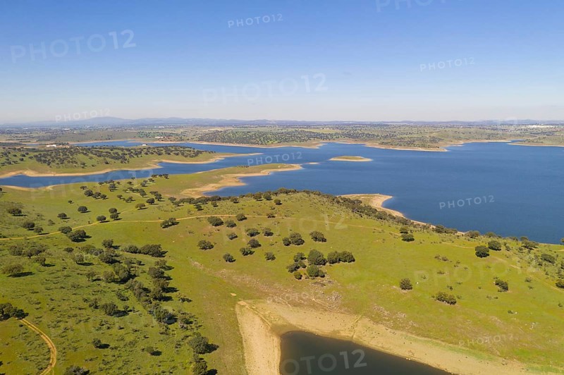 Dam lake reservoir drone aerial view of Barragem do Caia Dam olive trees landscape in Alentejo, Portugal, Europe