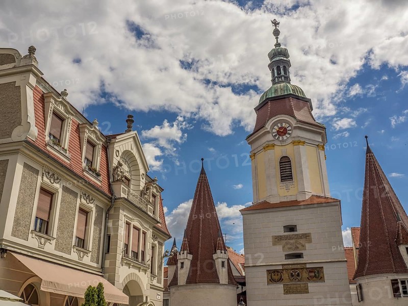 Historic buildings with church tower and spires, under a blue sky with clouds, Dürnstein, Wachau, Danube, Austria, Europe