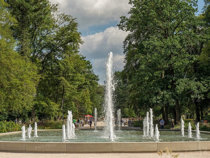 High rising water jet of a fountain in a green park on a sunny day, Bad Lippspringe, Germany, Europe