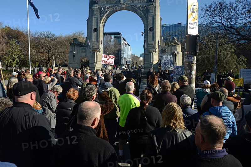 CHRISTCHURCH, NEW ZEALAND, JULY 24, 2021, People gather at a protest rally at the Bridge of Remembrance in Christchurch. Activists spoke against increasing government control over Covid vaccinations, farm taxes and civil liberties