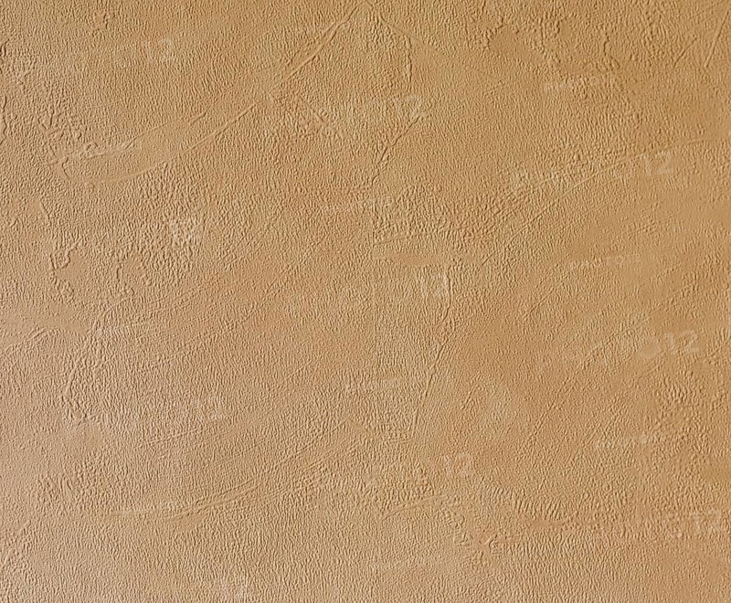 Light beige, roughly plastered house wall as full-format background
