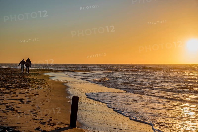 Den Helder, Netherlands. January 2022. Setting sun on the beach of Den Helder, Netherlands.