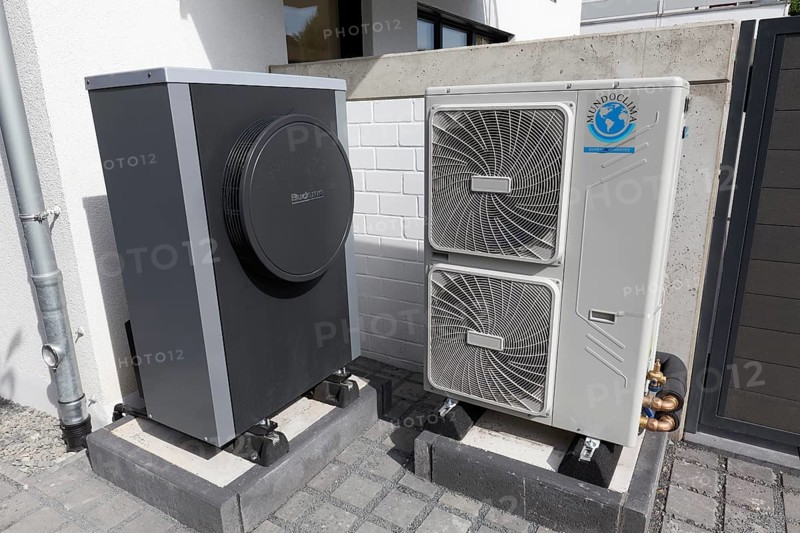 Outdoor units of an air-to-water heat pump in front of a newly built two-family house, heating and air conditioning, Düsseldorf, North Rhine-Westphalia, Germany, Europe