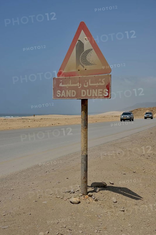 Warning sign warns of sand dunes, near Mirbat, Dhofar Region, Oman, Asia