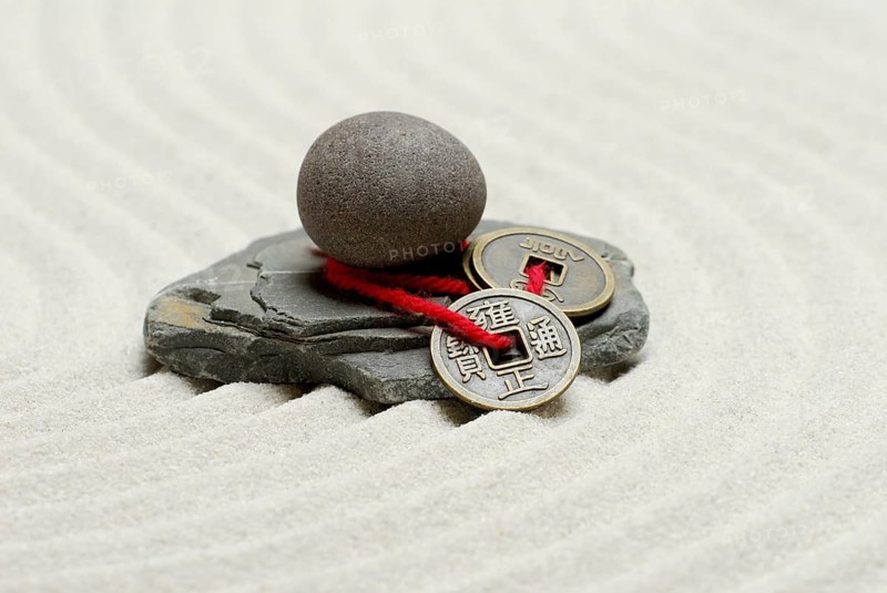 Stones and Chinese lucky coins, coins, lucky coins, lucky coin, coin, in sand