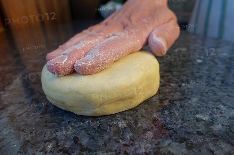 Swabian cuisine, preparing salted cream cake with spring onions, hearty cake, salty shortcrust pastry, shaping raw dough, baked, out of the oven, baked goods vegetarian, typical Swabian reinterpreted, baking, traditional cuisine, man's hand, worktop, food photography, studio, Germany, Europe
