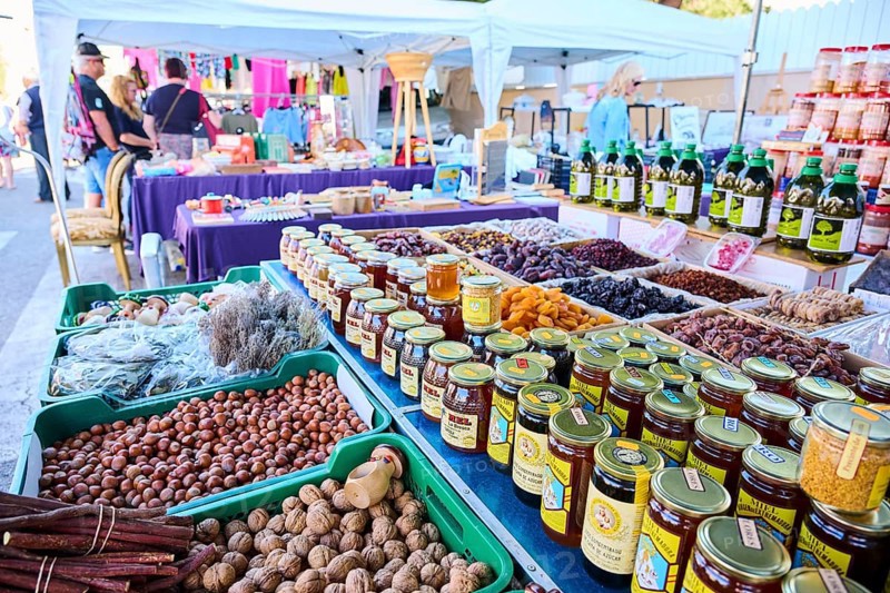 Market stall with honey und nuts and vegetables on a weekle market near Tarragona, Catalonia, Spain, Europe