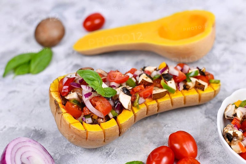 Vegan baked Butternut squash vegetable filled with bell pepper, cherry tomatoes, red onion and mushrooms