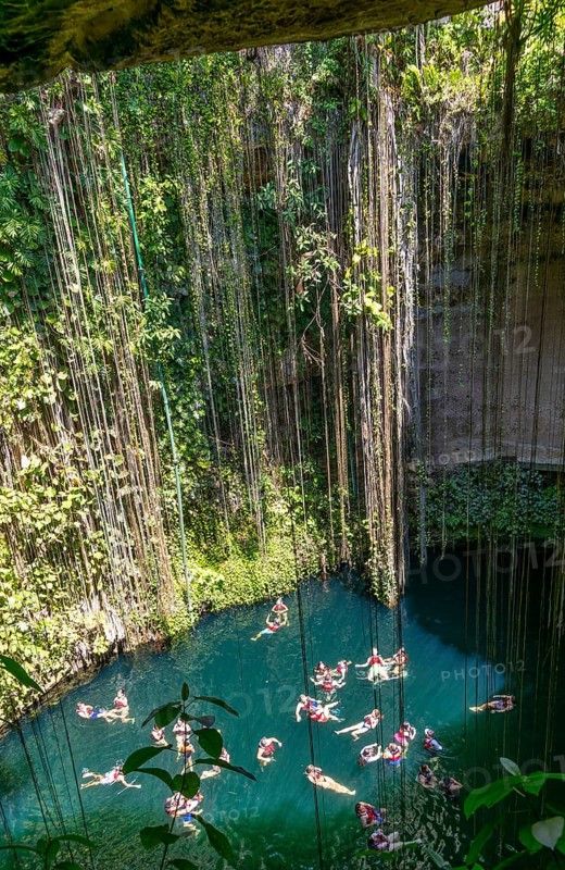 People swimming in limestone sinkhole pool, Cenote Ik kil, Pisté, Yucatan, Mexico, Central America