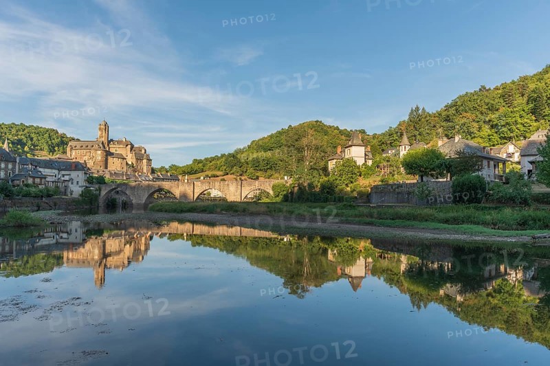 Medieval bridge over Lot with castle in village of Estaing. Aveyron, France, Europe