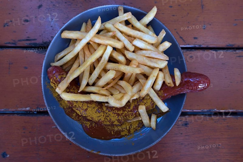 Currywurst served with fries in a beer garden, Bavaria, Deutschalmd