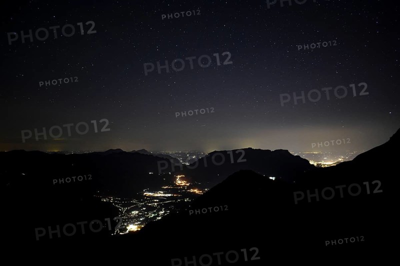 Night view of Berchtesgaden (centre) and Salzburg (right) with the Untersberg in between, seen from the mountains of Berchtesgaden National Park, Bavaria, Germany, Europe