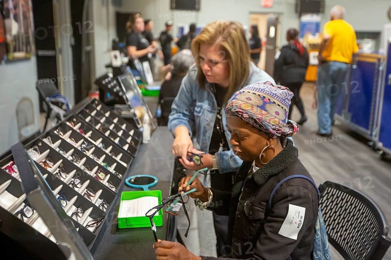 Detroit, Michigan, The OneSight Foundation organized a free clinic that offered eye exams and prescription glasses for low-income residents. A woman picks out frames for her new glasses. OneSight holds clinics in many parts of the world