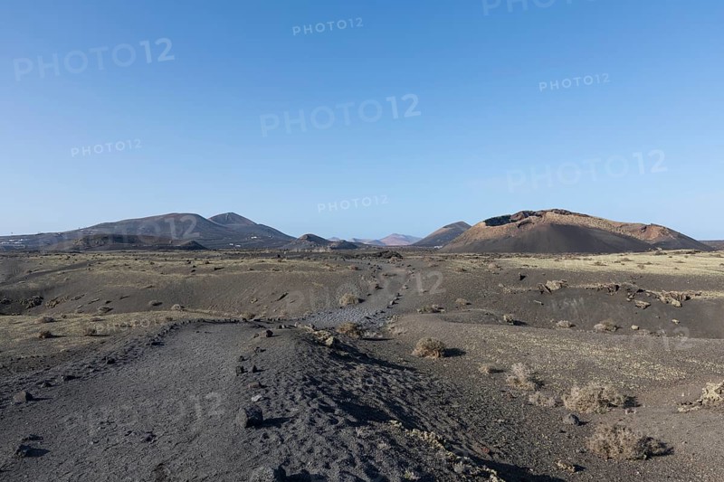 Path through the volcanic landscape to the Caldera de Los Cuervos volcano, Tias, Lanzarote, Canary Islands, Spain, Europe