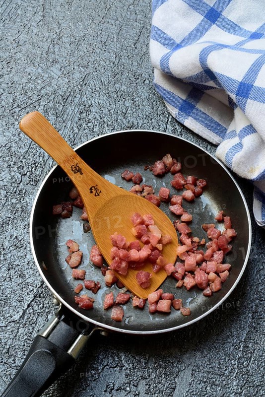Fried bacon cubes in pan, bacon