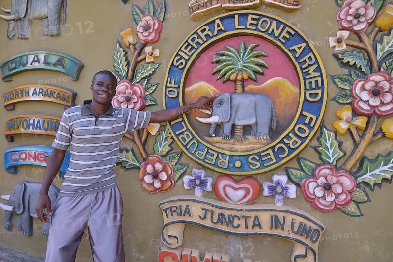Tour guide standing at the Sierra Leone Peace and Cultural Monument, Freetown, Sierra Leone, Africa