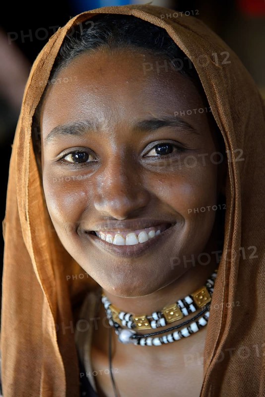 Young girl from a nomadic tribe, wearing headgear, portrait, Bayuda Desert, in Karima, Nubia, Northern Sudan, Sudan, Africa