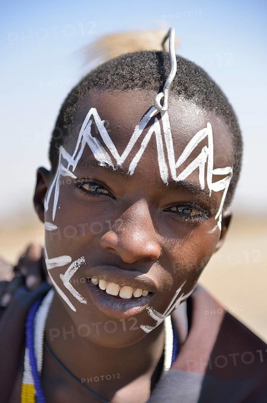 Young Maasai warrior with a painted face, Ngorongoro Conservation Area, Ndema, Tanzania, Africa