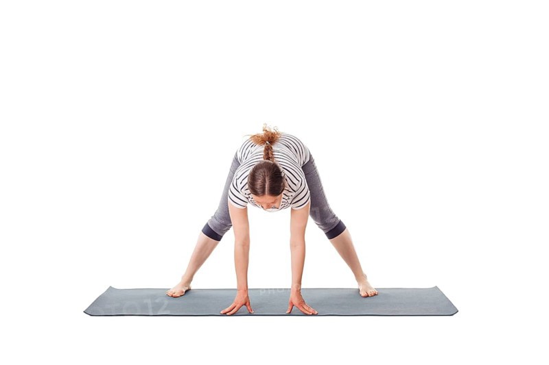 Pregnancy yoga exercise, pregnant woman doing yoga asana prasarita padottanasana A Wide-Legged Standing Forward Bend isolated on white background
