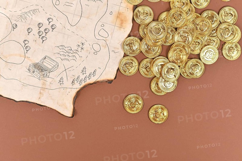 Hand drawn pirate treasure map with toy gold coins for children