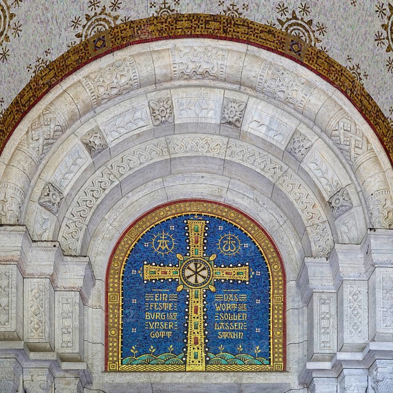 Cross mosaic in the tympanum with the quotation Eine feste Burg ist unser Glauben by Martin Luther, Lutherkirche, Wiesbaden, Hesse, Germany, Europe
