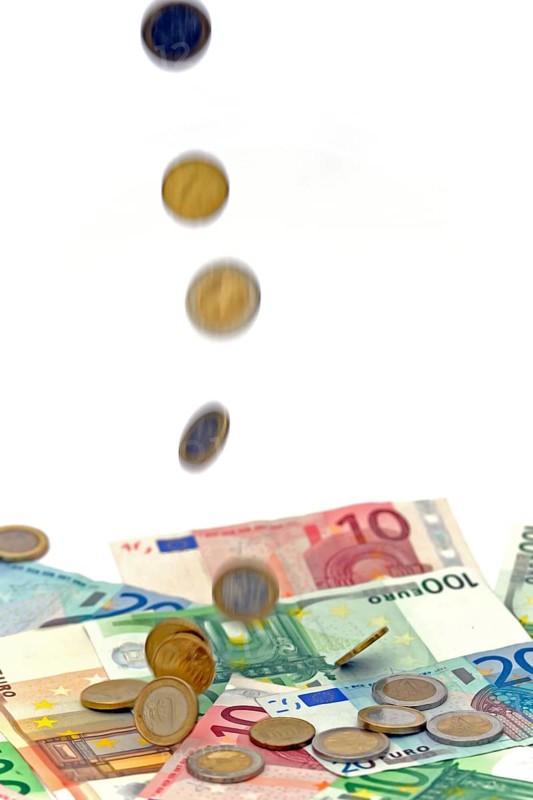 Euro coins fall on euro banknotes, rain of money, high cost, symbolic image