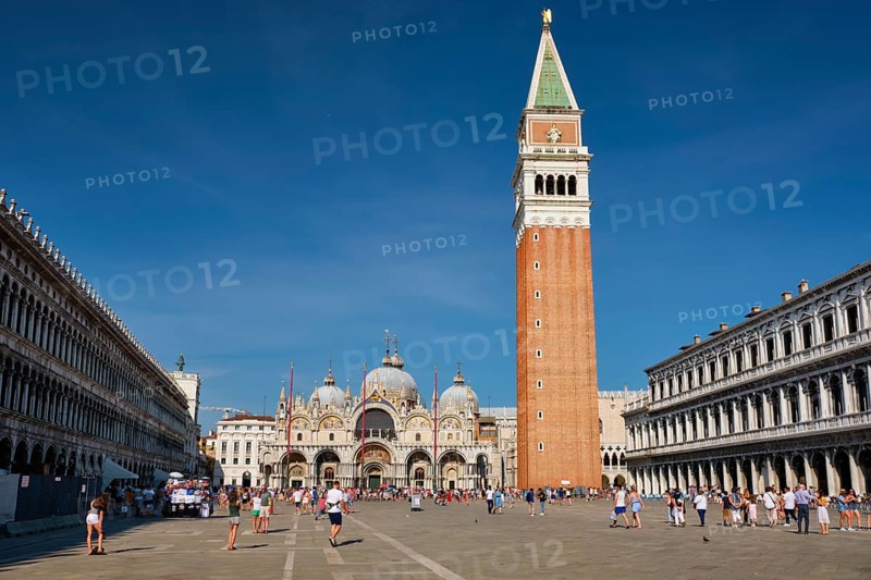 VENICE, ITALY, JULY 19, 2019: St Mark's Basilica and San Marco square with Campanile di San Marco bell tower with tourists in Venice, Italy, Europe
