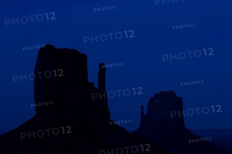 Rock formation the Mittens, sandstone rocks silhouetted at night, Monument Valley Navajo Tribal Park, Arizona, Utah, US
