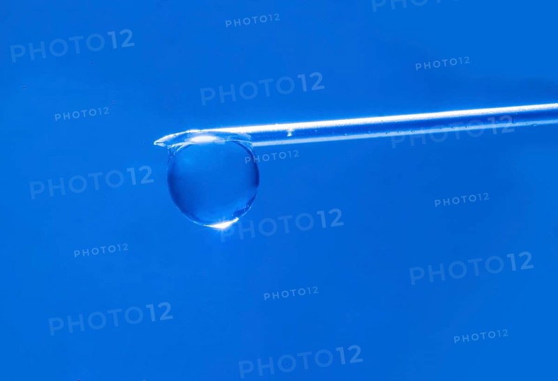 Macro image Covid vaccine, a drop of Moderna vaccine hangs on a vaccine needle