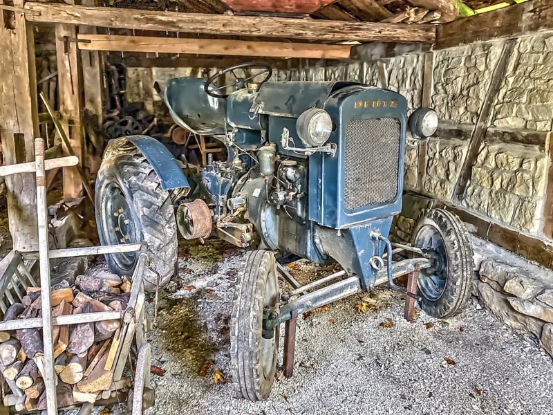 In old sil photographed historical tractor Deutz type F1M 414-46 11-series 1-cylinder year of construction 1946 in unrestored condition in historical storage place in farm in open-air museum Neuhausen, Neuhausen ob Eck, district Tuttlingen, Baden-Württemberg, Germany, Europe