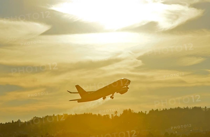 Airbus of the airline Swiss International Air Lines after take-off in climbing departure against the light, Zurich Airport, Zurich, Switzerland, Europe