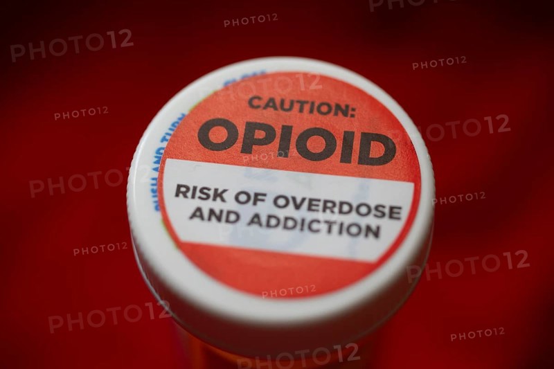 A label on a bottle of hydrocodone-acetamin opioid prescription pills warns against the danger of overdose and addiction