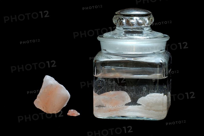 Saturated salt solution in glass container, brine, salt-water solution, Himalayan salt, salt crystals, salt