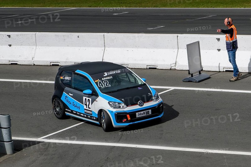 Racing car for series VW up! GTI Cup with driver Leon Arndt is marshalled into Parc Fermé by track marshal Racing Steward after car race, ADAC Racing Weekend, TT Circuit Assen, Assen, Province of Drenthe, The Netherlands, Europe