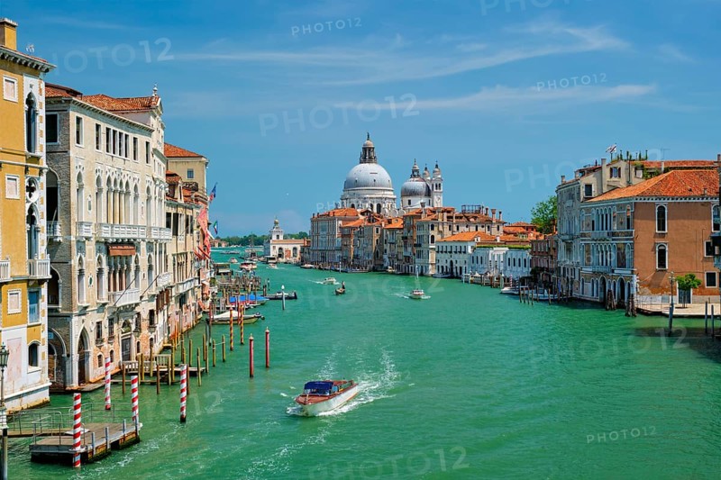 View of Venice Grand Canal with boats and Santa Maria della Salute church in the day from Ponte dell'Accademia bridge. Venice, Italy, Europe
