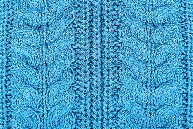 Close up of knitted pattern on blue wool pullover