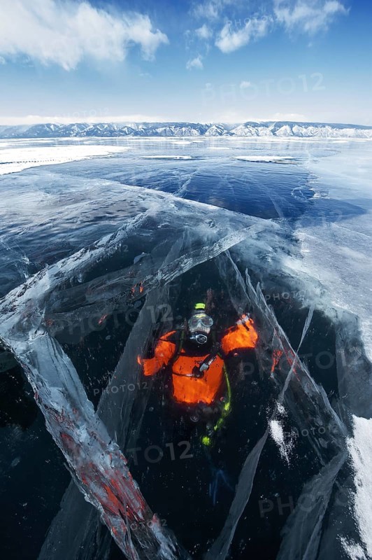 Scuba diver under ice, Lake Baikal, Pribaikalsky National Park, Irkutsk Province, Siberia, Russia, Europe