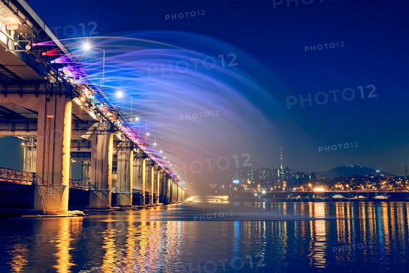 SEOUL, SOUTH KOREA, APRIL 7, 2017: Banpo Bridge Rainbow Fountain tourist landmark on Han river illuminated at night, Seoul, South Korea, Asia