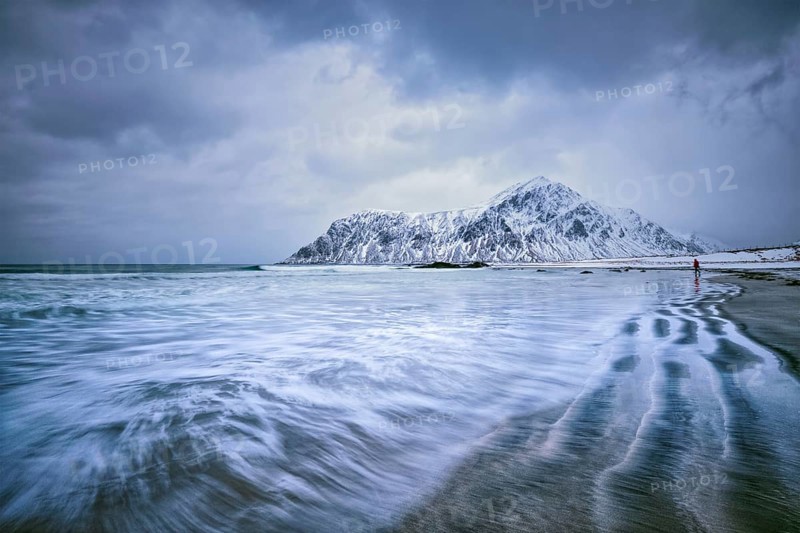 Waves on coast of Norwegian sea in fjord. Skagsanden beach, Flakstad, Lofoten islands, Norway. Long exposure motion blur