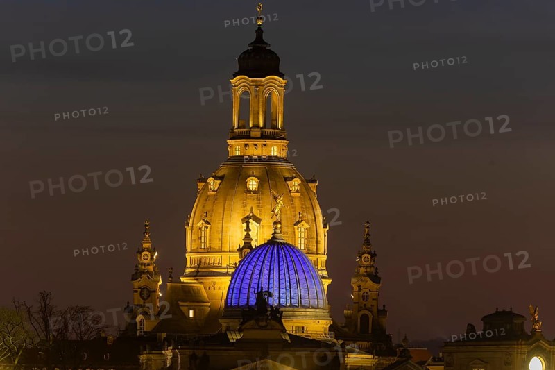 The Church of Our Lady with the glass dome over the octagon of the Academy of Arts, which is illuminated in blue in protest against the war in Ukraine