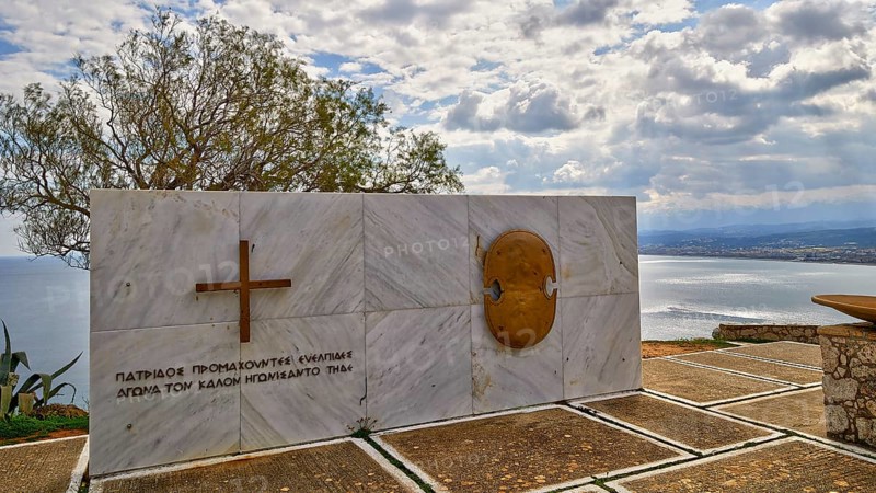 HDR, war memorial to Greek cadets of WW2, marble slab, cloudy dramatic sky, east coast of Rodopou peninsula, western Crete, island of Crete, Greece, Europe