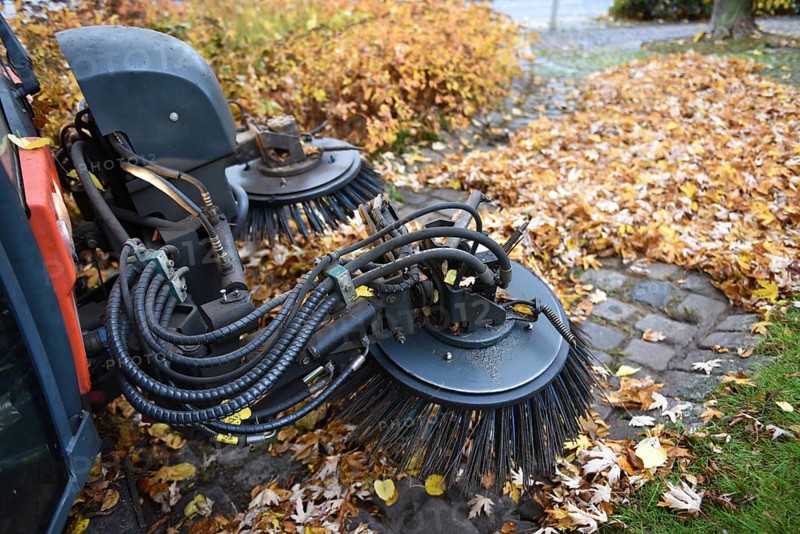 Sweeper sweeping wilted leaves in autumn, Vellmar, Hesse, Germany, Europe